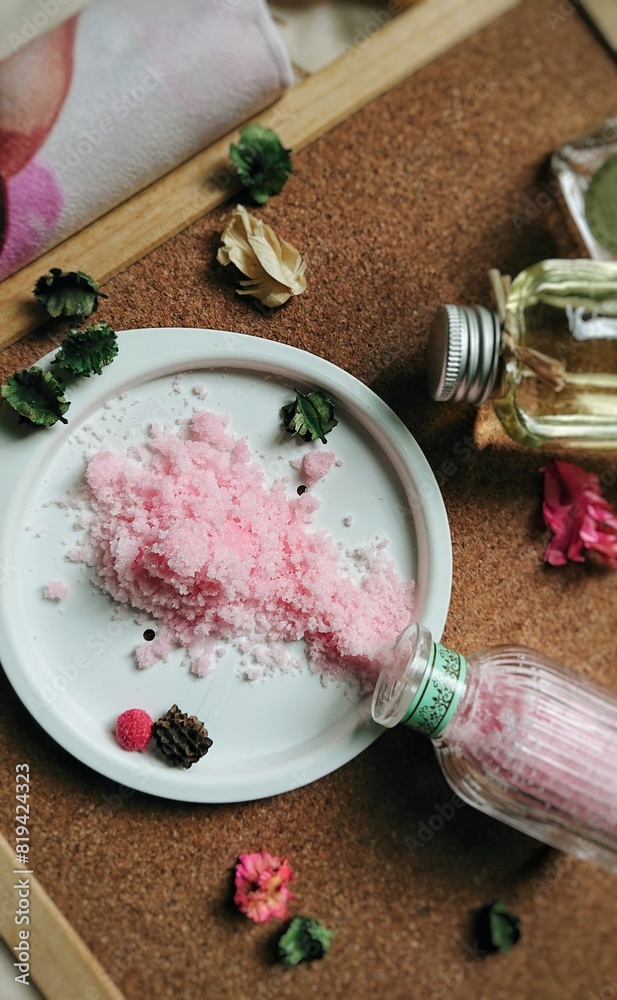Composition of spa products, pink sea salt in a white plate on a wooden background. Composition of spa products, pink sea salt in a white plate on a wooden background.