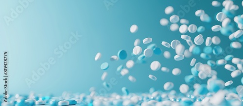Floating white and blue pills on blue background photo