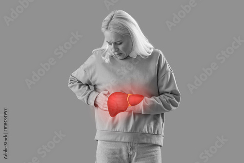 Konstfotografi Mature woman suffering from side pain on green background