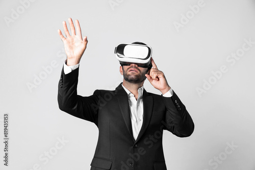 Smart business man with suit holding something while VR goggle to connect metaverse. Professional project manager looking at hologram by using visual reality headset. Technology innovation. Deviation.