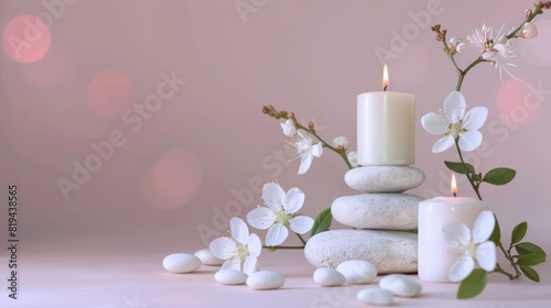 Serene spa scene with white candles on stacked stones  adorned with delicate flowers and soft  ambient lighting.