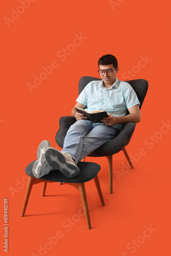 Young man reading book in a...