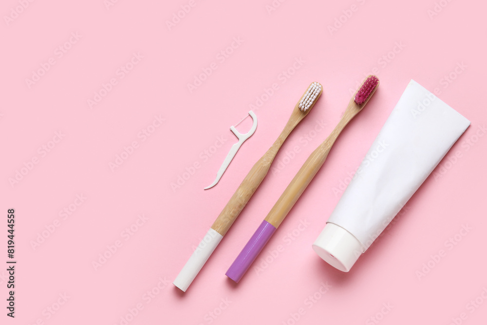 Toothbrushes, floss toothpick and toothpaste on pink background. World Dentist Day Toothbrushes, floss toothpick and toothpaste on pink background. World Dentist Day