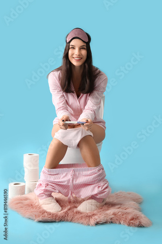 Happy young woman in pajama...