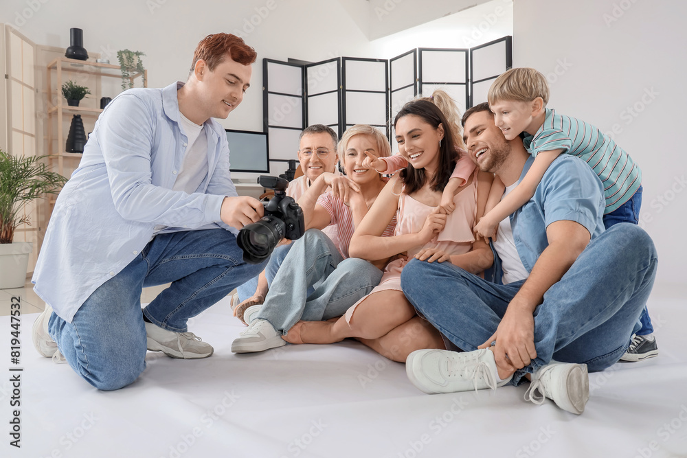 Big family looking at taken pictures in studio