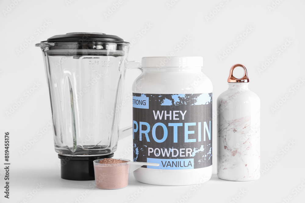 Bottle of protein powder, water and blender on light background Bottle of protein powder, water and blender on light background