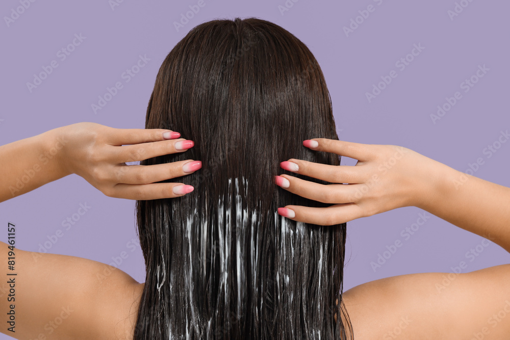 Young woman with hair mask on lilac background, back view Young woman with hair mask on lilac background, back view