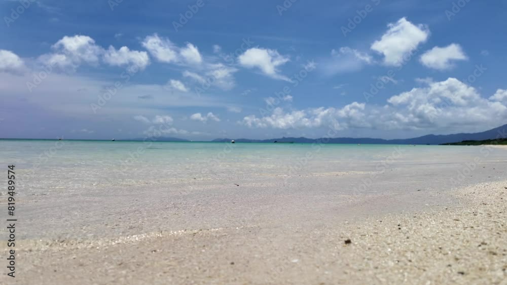 Sunny Beach With Clear Waters, Blue Sky, And Fluffy Clouds Sunny Beach With Clear Waters, Blue Sky, And Fluffy Clouds