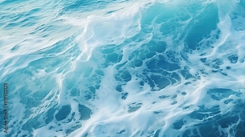 Blue ocean with white waves crashing on the shore. Image of a serene blue ocean with frothy white waves. © QBeStock