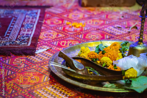 Religious items for hindu puja rituals kept on copper plate for performing the rites. Marigold flowers and copper utensils are symbolic to traditional hindu culture. photo