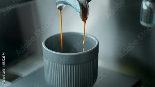 Pouring  Espresso Into a Cup from the Coffee Maker photo