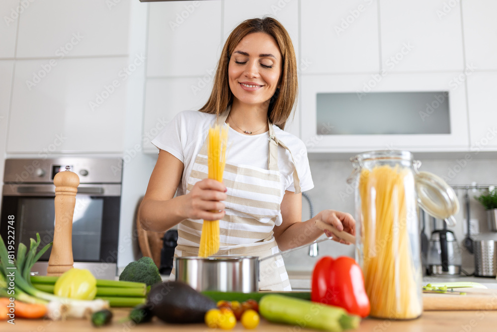 Happy Young Woman Cooking Tasting Dinner In A Pot Standing In Modern Kitchen At Home. Housewife Preparing Healthy Food Smiling . Household And Nutrition. Dieting Recipes Concept Happy Young Woman Cooking Tasting Dinner In A Pot Standing In Modern Kitchen At Home. Housewife Preparing Healthy Food Smiling . Household And Nutrition. Dieting Recipes Concept