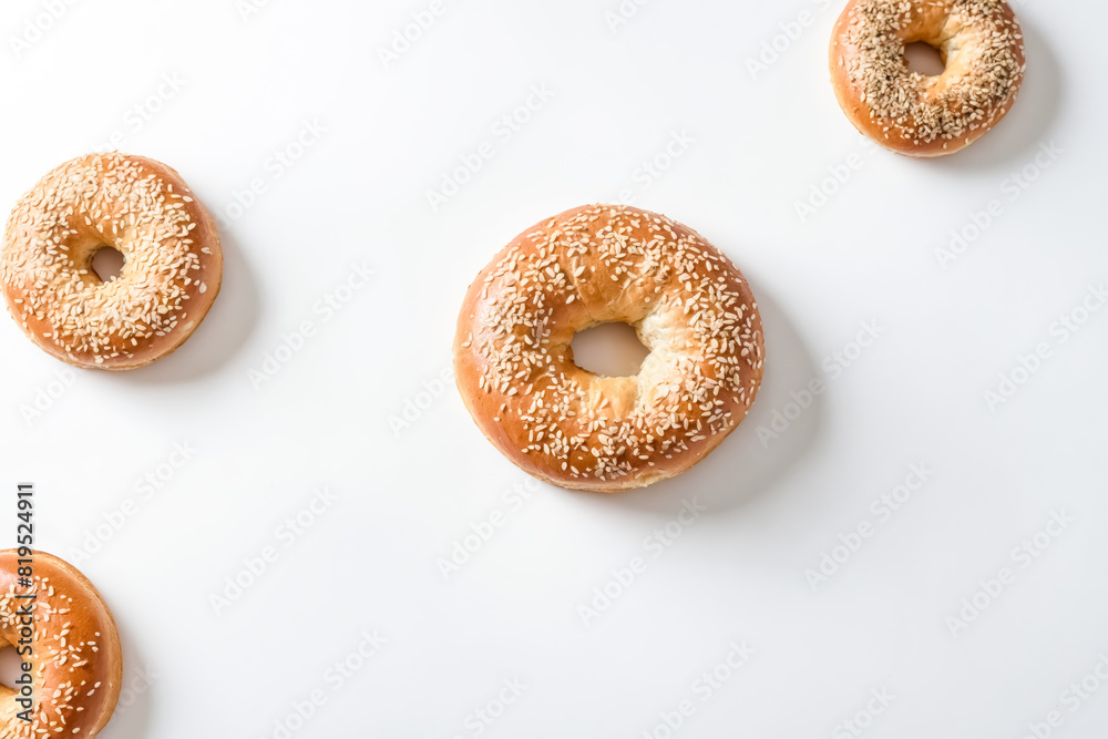 Freshly Baked Bagels with Sesame Seeds on White Background Freshly Baked Bagels with Sesame Seeds on White Background