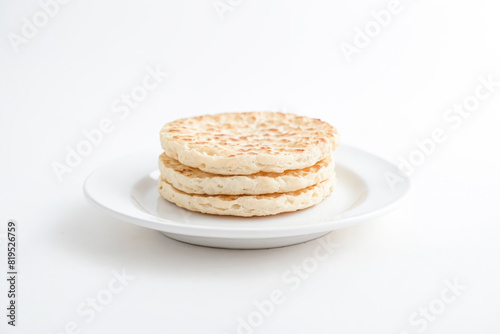 Close-up of Three Crumpets on a White Plate