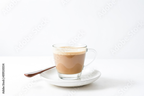Coffee with Milk in a Glass Cup on a White Saucer
