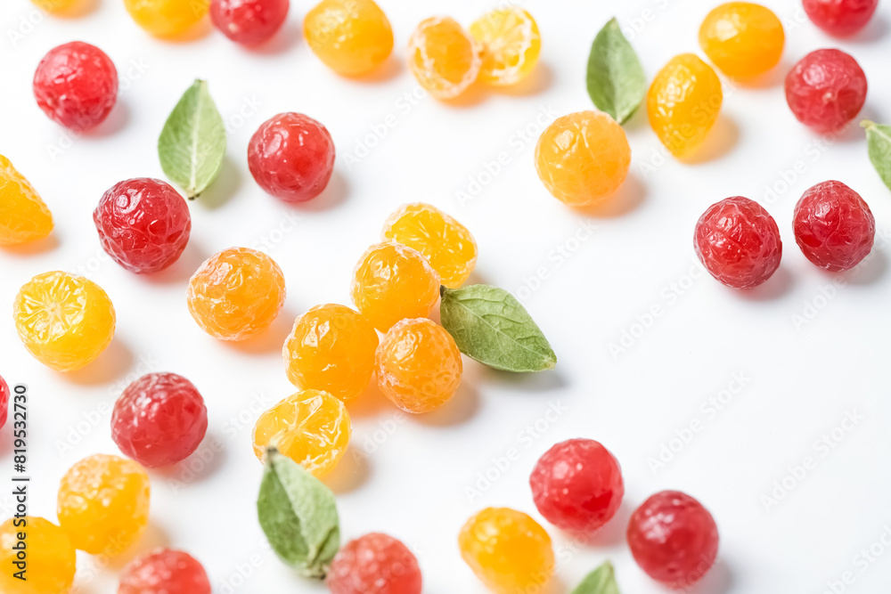 Colorful Candied Fruit with Green Leaves on White Background Colorful Candied Fruit with Green Leaves on White Background
