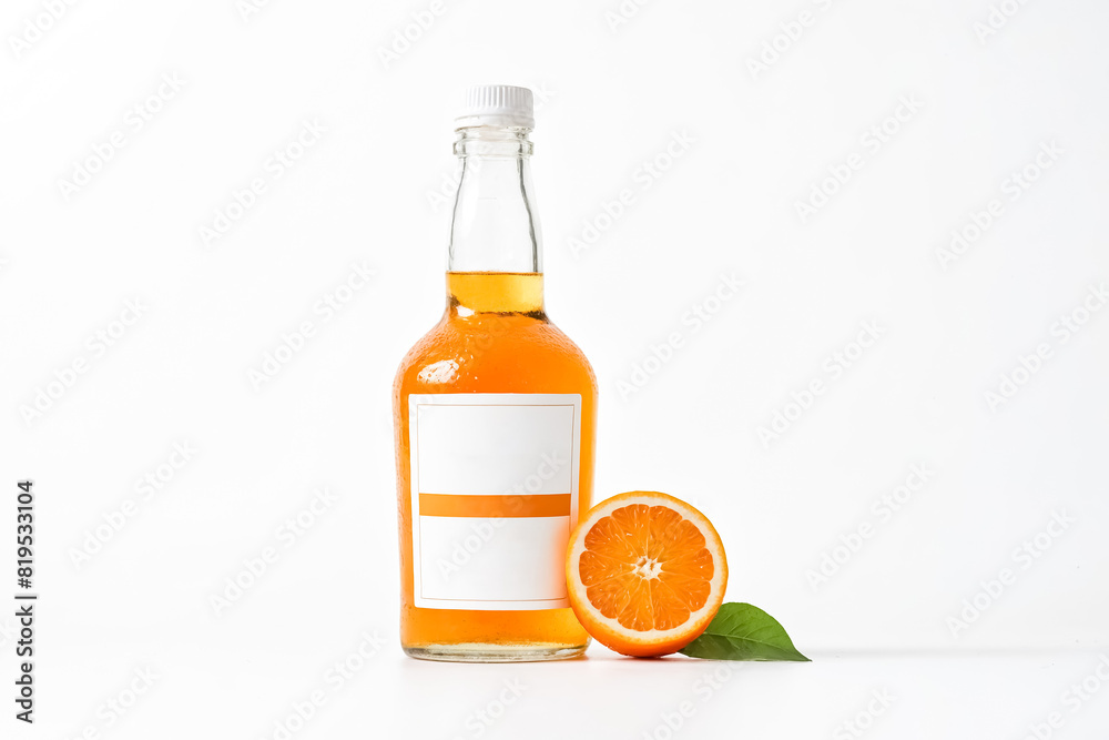 Glass Bottle of Orange Juice with Orange Slice and Leaf on White Background Glass Bottle of Orange Juice with Orange Slice and Leaf on White Background
