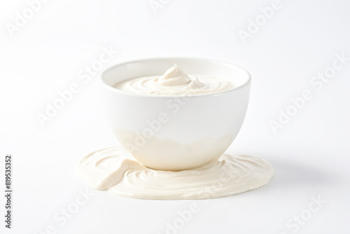 Bowl of Creamy Yogurt Spilled on White Surface