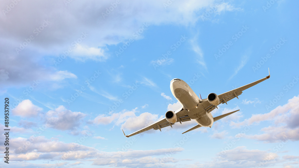 White passenger airplane flying in the sky amazing clouds in the background - Travel by air transport White passenger airplane flying in the sky amazing clouds in the background - Travel by air transport
