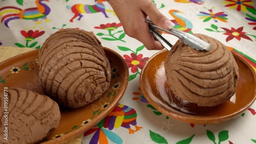 traditional chocolate-flavored Mexican bread, known as conchas, on a Mexican table photo