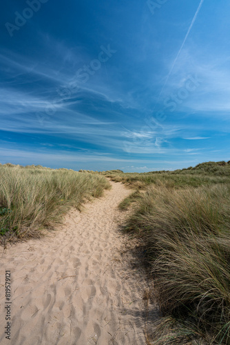 Sand dunes and beach at Talacre a popular tourist destination in North Wales on a bright sunny summer day.