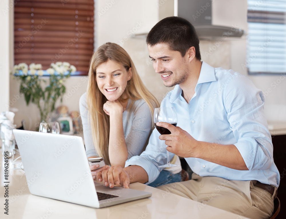 Happy couple, laptop and browsing with wine glass in kitchen for online shopping, research or news at home. Young man and woman with smile on computer for checking renovation or dinner date at house Happy couple, laptop and browsing with wine glass in kitchen for online shopping, research or news at home. Young man and woman with smile on computer for checking renovation or dinner date at house