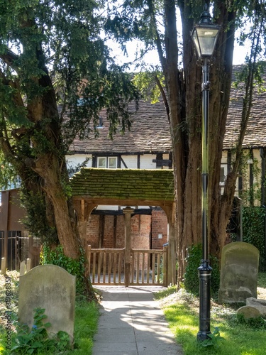 headstones with the lychgates of Chalfont St Giles Church in the background Buckinghamshire England photo