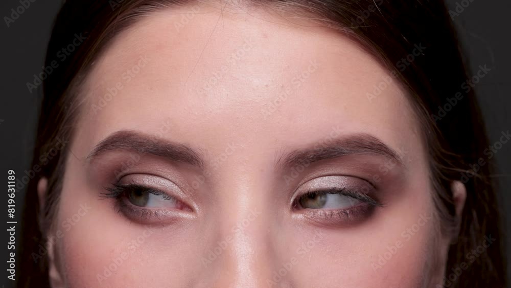 Beautiful green-eyed girl. A girl with a beautiful make-up looks at the camera close-up. Professional make-up and cosmetic skin care. Beautiful green-eyed girl. A girl with a beautiful make-up looks at the camera close-up. Professional make-up and cosmetic skin care.