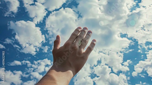 Person raising hands in prayer, spiritual connection to the sky. photo