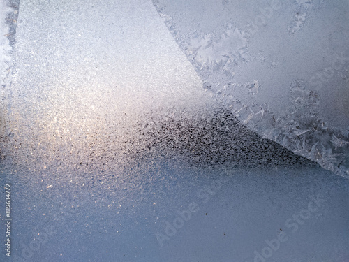 Blue Frost Background, Closeup Frozen Winter Window Pane Coated Shiny Icy Frost Patterns. Natural Ice Pattern on a Frosty Glass