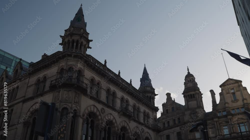 Manchester, UK - The atmosphere of King Street in Manchester with the iconic Manchester Reform Club and Spring Gardens buildings in the background. Manchester, UK - The atmosphere of King Street in Manchester with the iconic Manchester Reform Club and Spring Gardens buildings in the background.