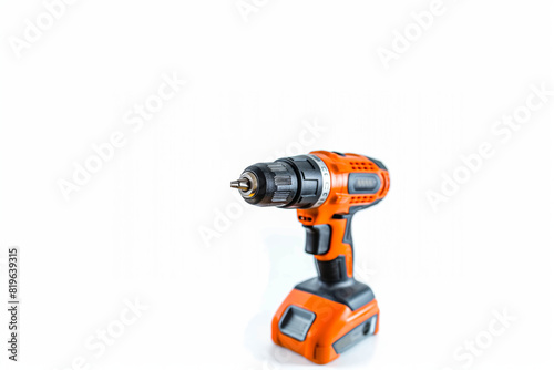 A bright orange cordless drill sits atop a clean white surface. Copy Space. Isolated. Generative AI