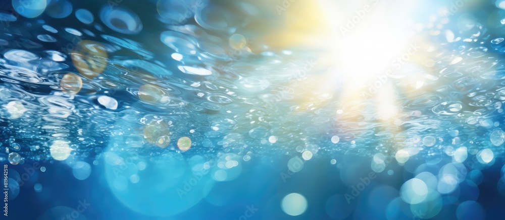 A trendy abstract nature background featuring de focused blurred transparent blue water surface with splashes bubbles and water waves sparkling in sunlight next to copy space image A trendy abstract nature background featuring de focused blurred transparent blue water surface with splashes bubbles and water waves sparkling in sunlight next to copy space image