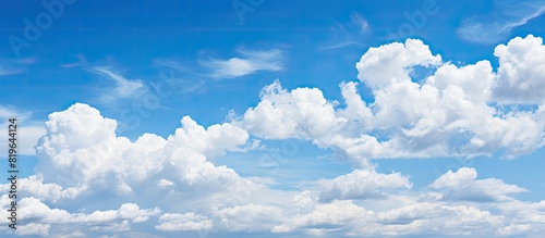 Background image of a clear blue sky with fluffy white clouds perfect for copy space image
