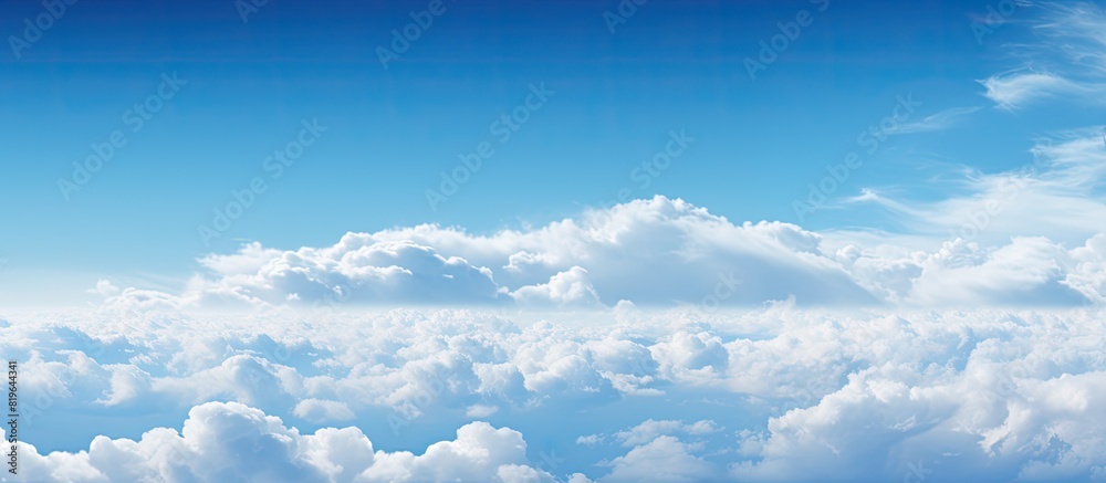 Sky filled with fluffy white clouds against a serene backdrop enhancing the beauty of the blue expanse and offering copy space image