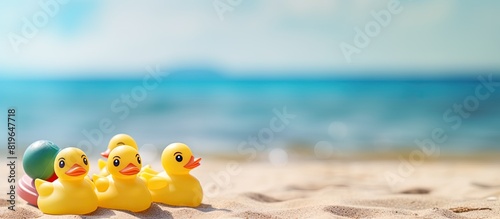 Rubber duck and beach toys on wooden surface with copy space image photo