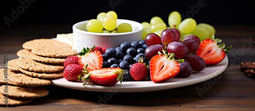 A fresh and healthy snack with crispbread fruits berries hamon and cheese displayed on a plate with copy space image photo