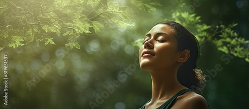 A woman in a serene forest breathing in crisp air with a copy space image for added detail