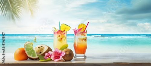Two delicious cocktails placed invitingly on a tropical white beach with a serene ocean view creating an idyllic scene with a copy space image