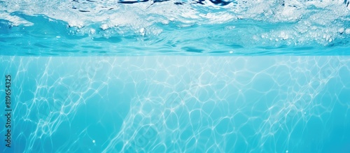 Vivid blue water glistens in the swimming pool creating a serene backdrop for a copy space image