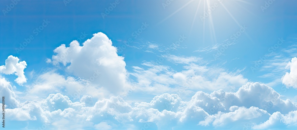 Clear blue sky with fluffy white clouds combined with warm sunshine and a cool breeze against your skin creating a refreshing paradise like scene. Copy space image. Place for adding text and design