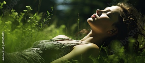 Woman lying in the grass dreaming of a bright future with copy space image photo