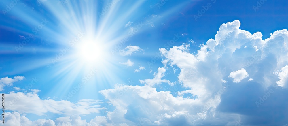 Blue sky with white clouds and bright sun perfect for a copy space image Blue sky with white clouds and bright sun perfect for a copy space image