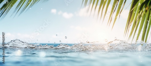 A scenic summer vacation backdrop with golden sands palm leaves out of focus and sparkling water highlights on a sunny day ideal for travel with a copy space image