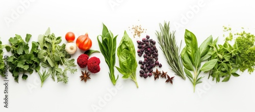 A top down view of aromatic herbs and spices like sage thyme mint basil and green chili from the garden on a white background with copy space image