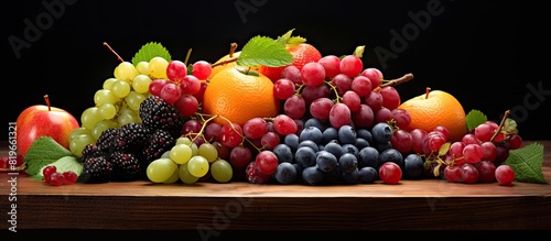 Table displaying a variety of fresh fruits like raspberries apricots and grapes with copy space image