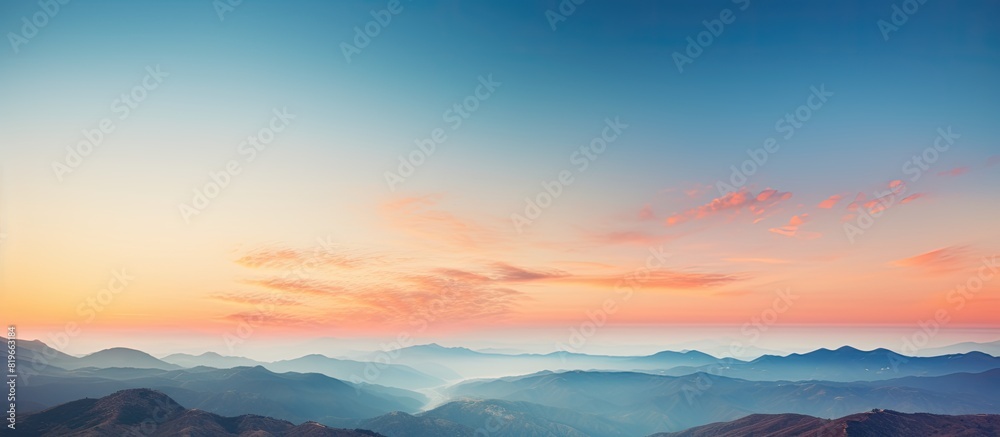 Scenic sunset sky over mountains with orange and blue hues offers a beautiful nature background ideal for a photo with copy space image Scenic sunset sky over mountains with orange and blue hues offers a beautiful nature background ideal for a photo with copy space image