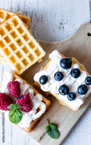 
Belgian Waffles with cream and fruit. on a wooden background. dessert