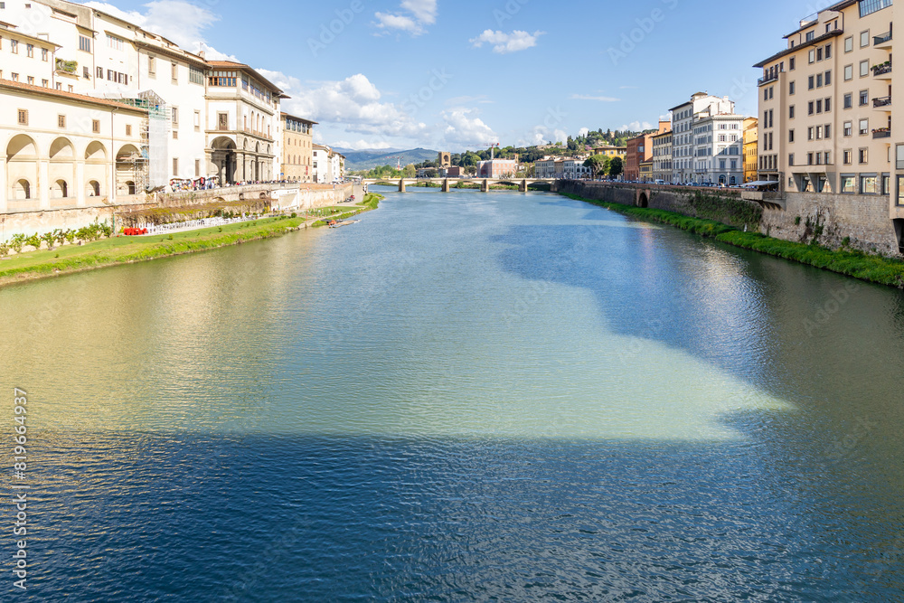Fototapeta premium Florence, Italy - April 10, 2024: View of the Santa Trinita Bridge in Florence with tourists crowding its surroundings in Florence, Italy