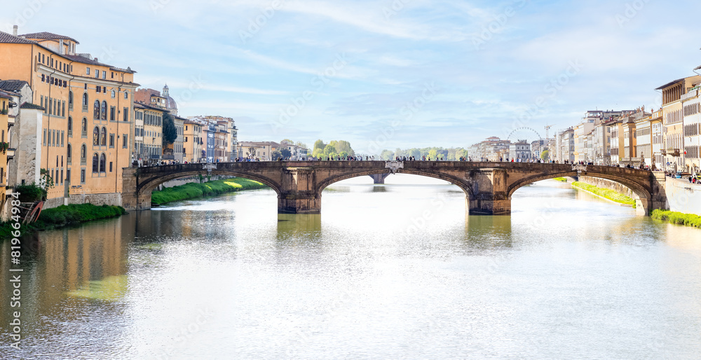 Florence, Italy - April 10, 2024: View of the Santa Trinita Bridge in Florence with tourists crowding its surroundings in Florence, Italy Florence, Italy - April 10, 2024: View of the Santa Trinita Bridge in Florence with tourists crowding its surroundings in Florence, Italy